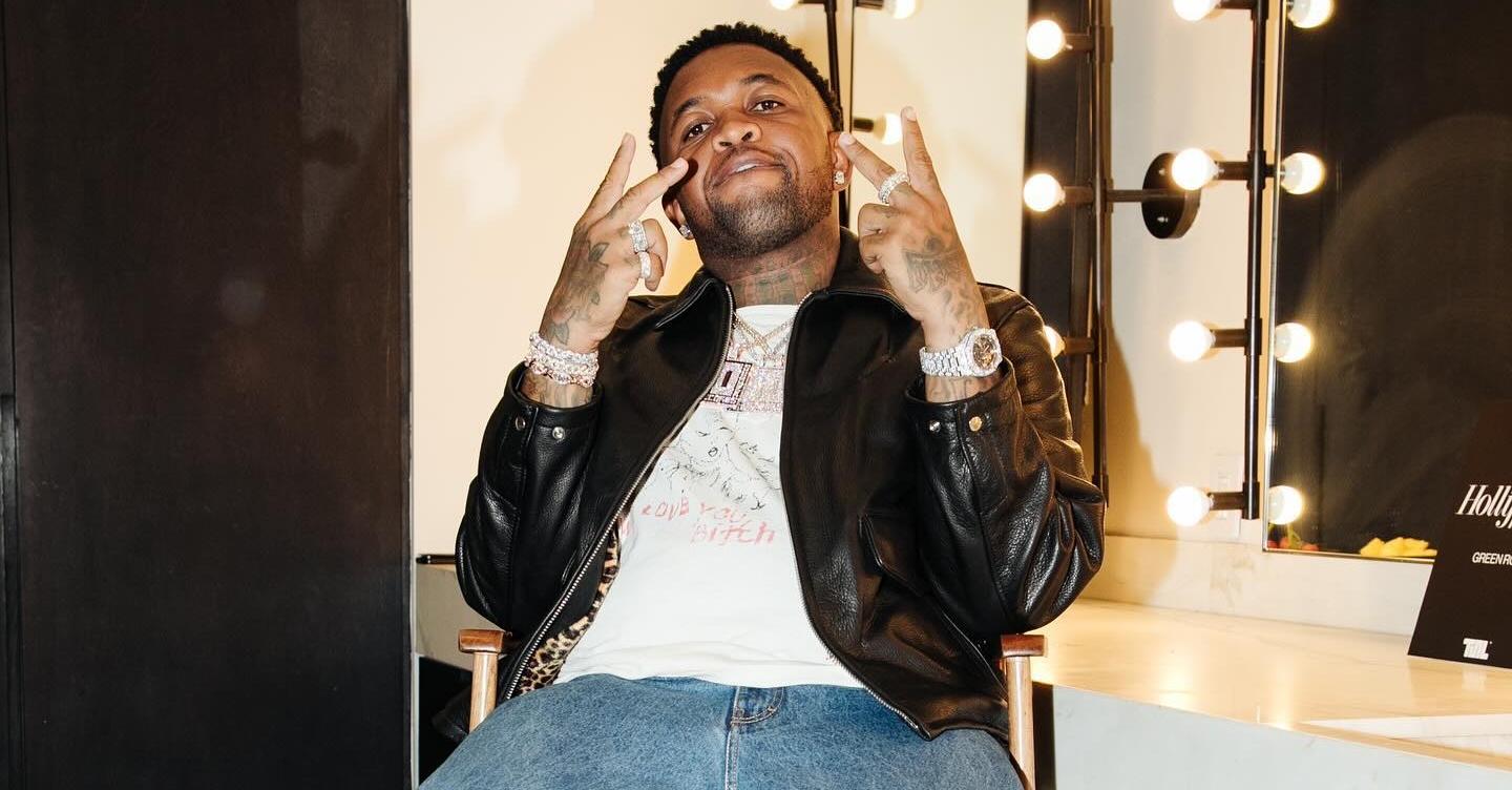 DJ Mustard poses in a dressing room.