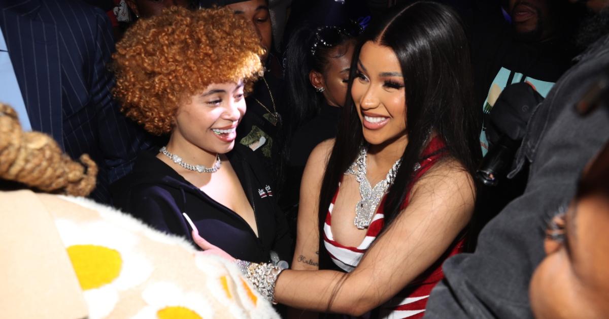 Ice Spice and Cardi B smiling and hugging each other.